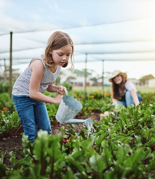 Young Girl Watering Plants
