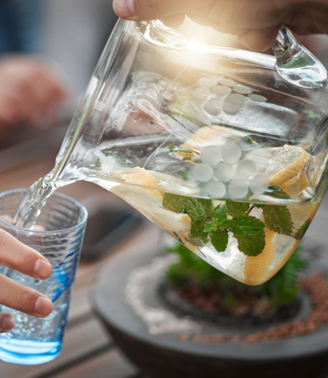 Pouring Lemon Water into Glass cup